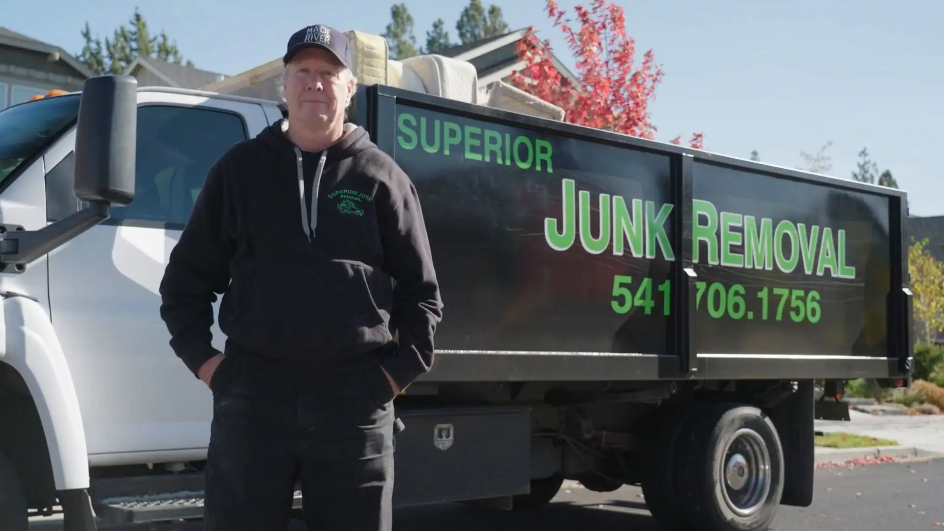 Calvin Belshaw in front of the Superior Junk Removal truck