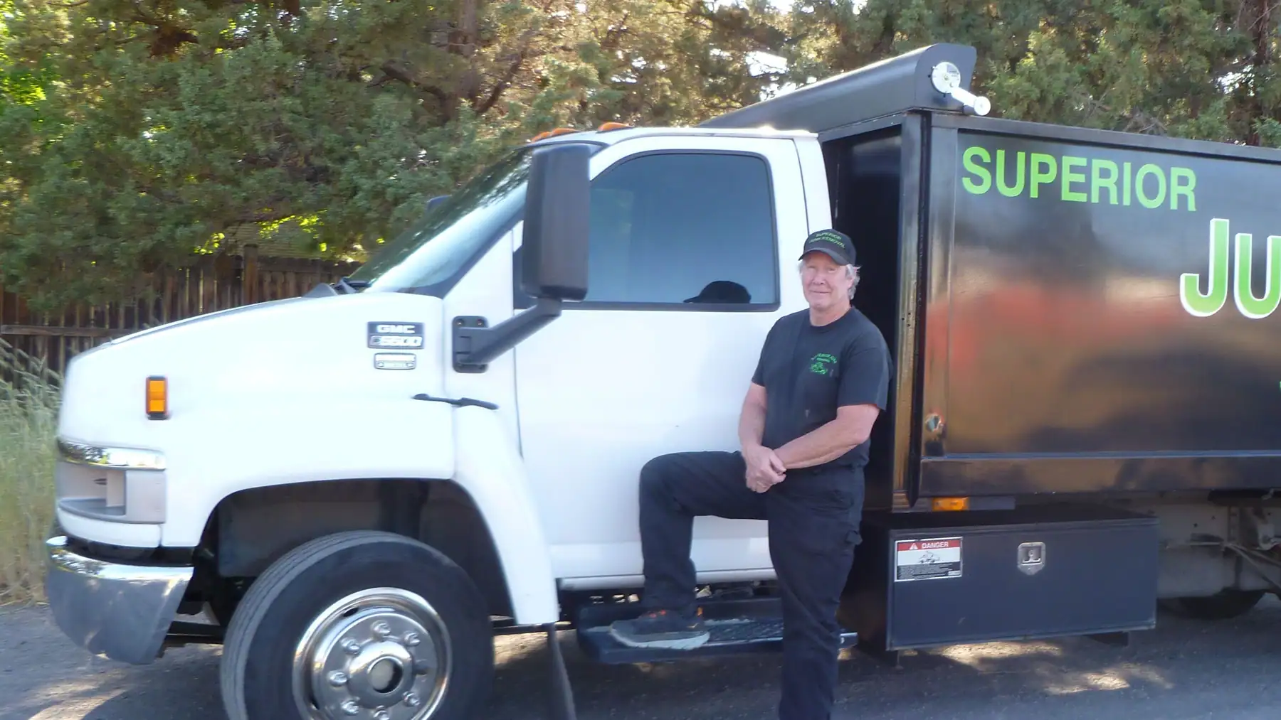Calvin Belshaw standing by the Superior Junk Removal truck