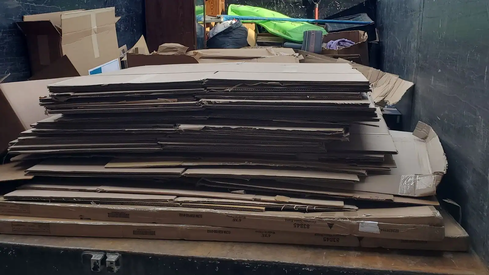 Flattened cardboard from a business loaded in the truck bed