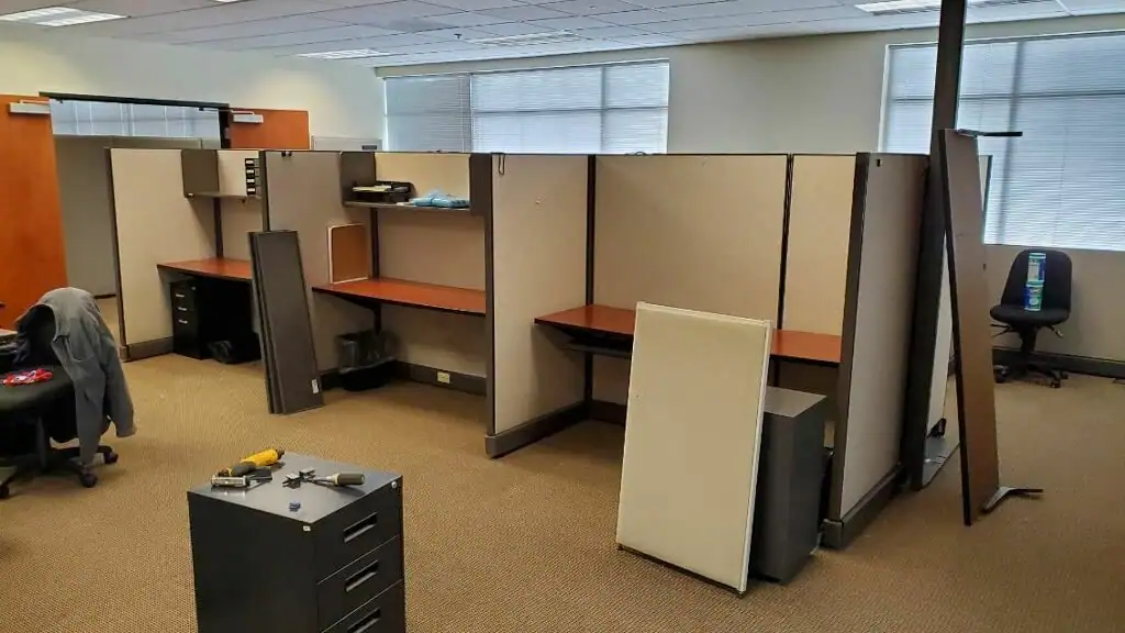 Office cubicles being taken apart during a commercial cleanout