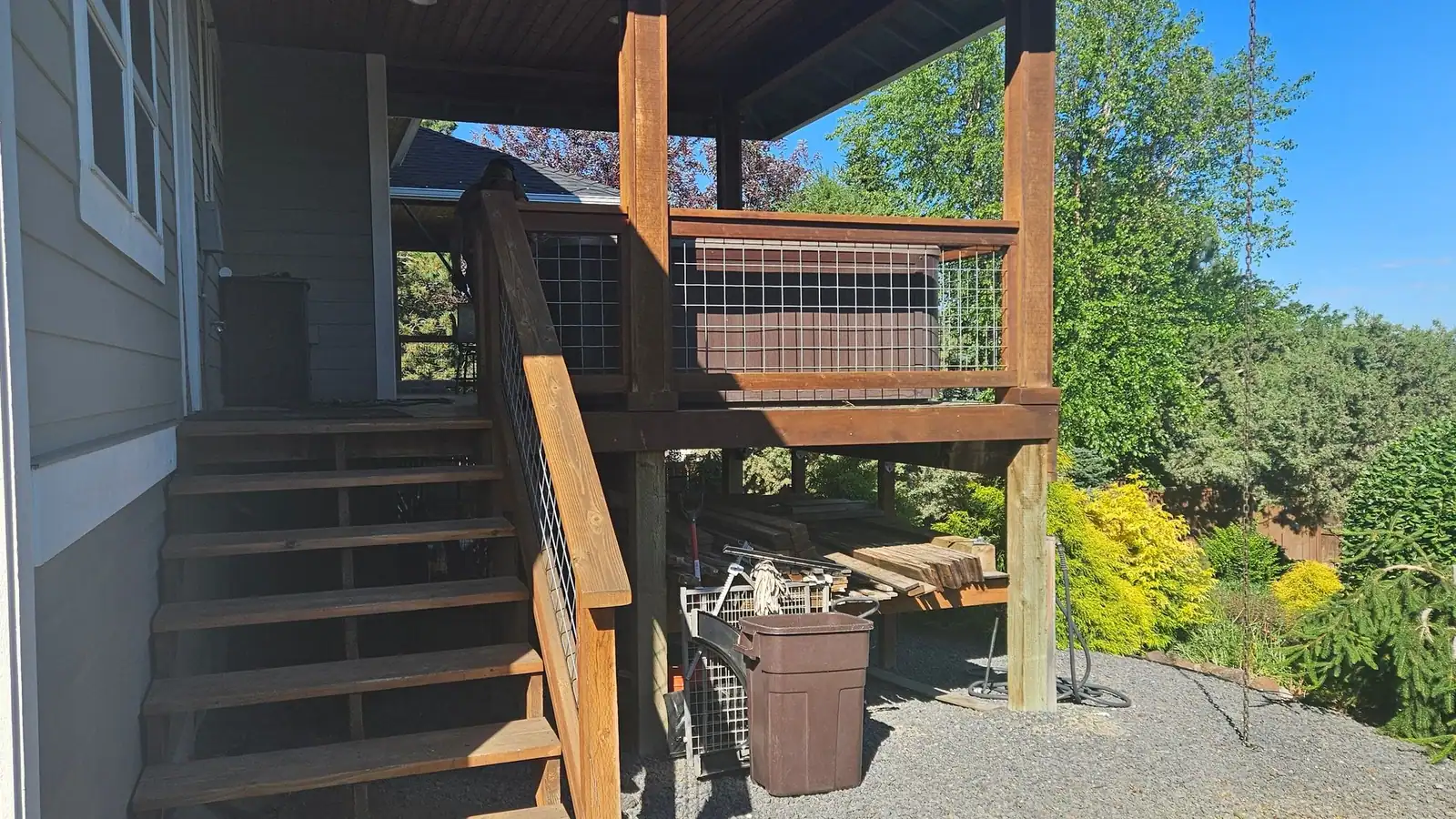 An old raised deck with wood stairs and railings