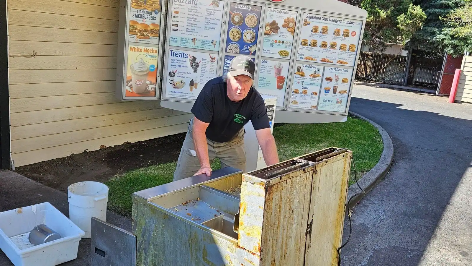 Calvin pulling old equipment from behind a fast food restaurant