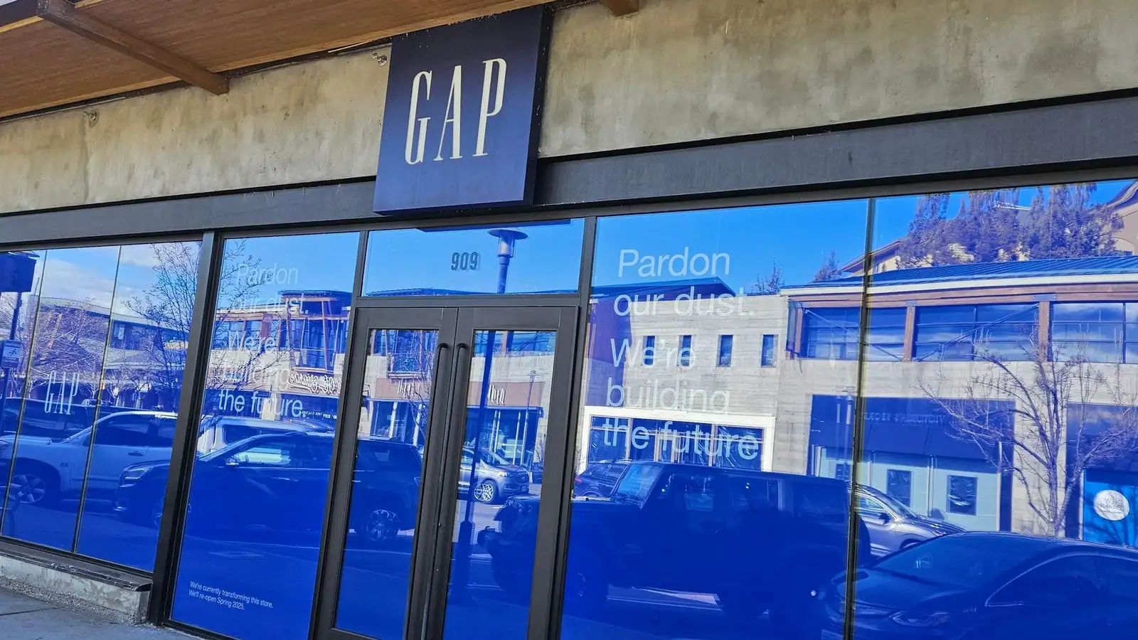 A retail storefront closing out, with paper over the windows