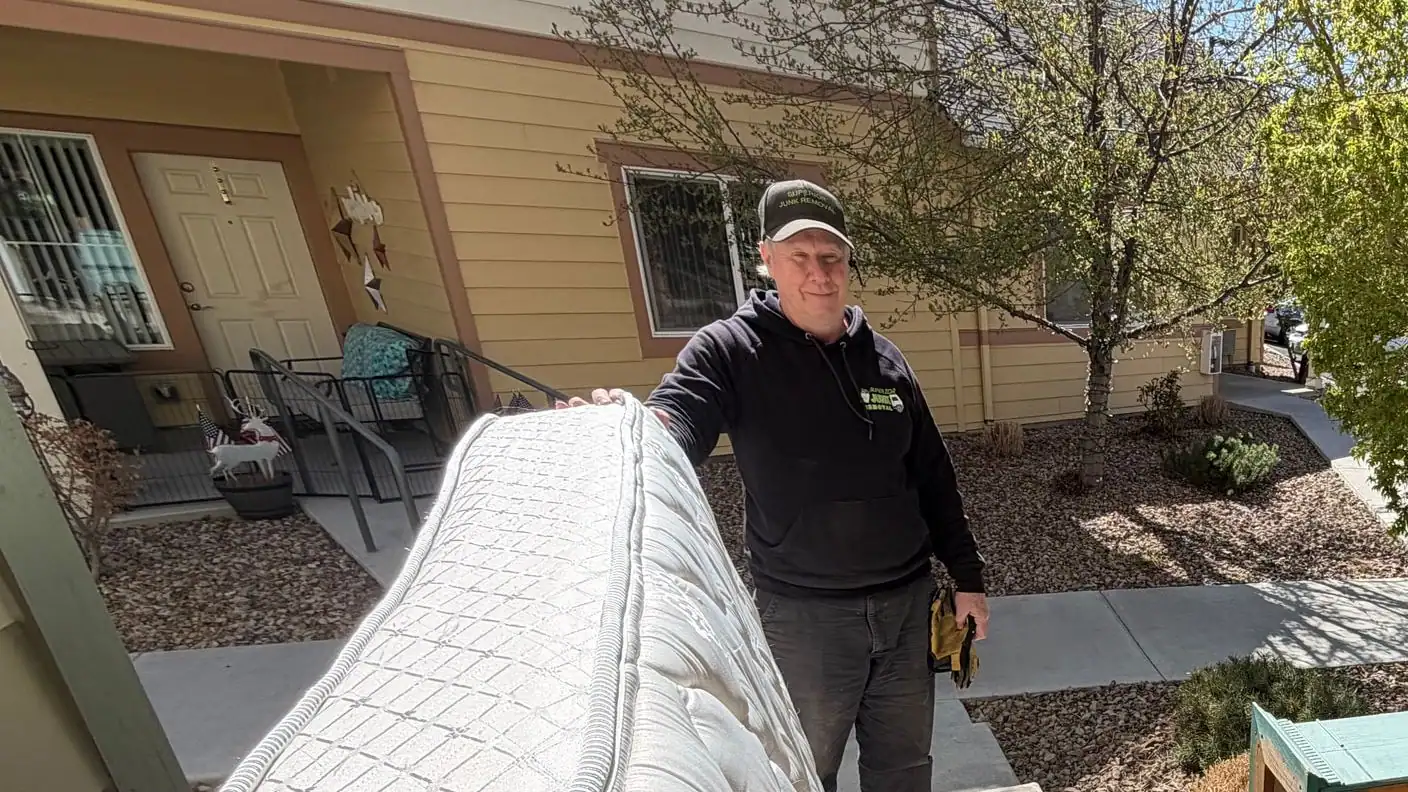 Calvin by the truck with a mattress and a wood bed frame ready to load