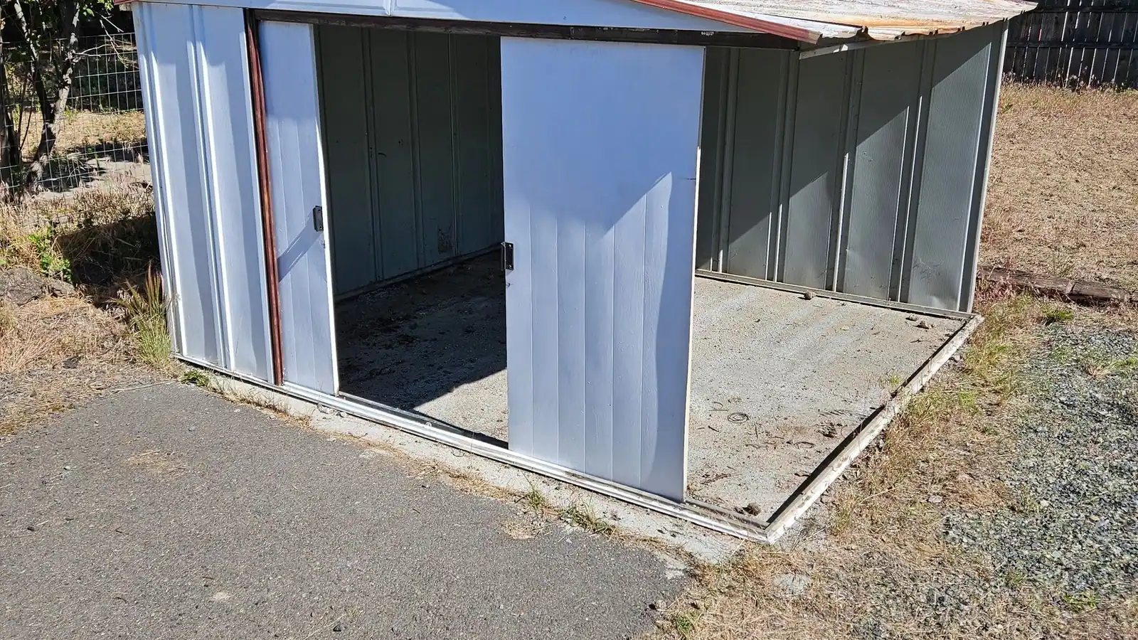 An old metal shed with its sliding door open