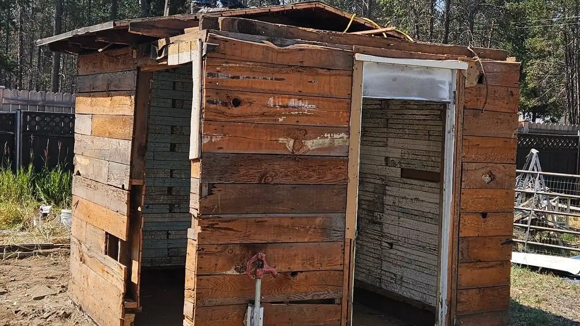 An old wooden shed with plank walls and two open doorways