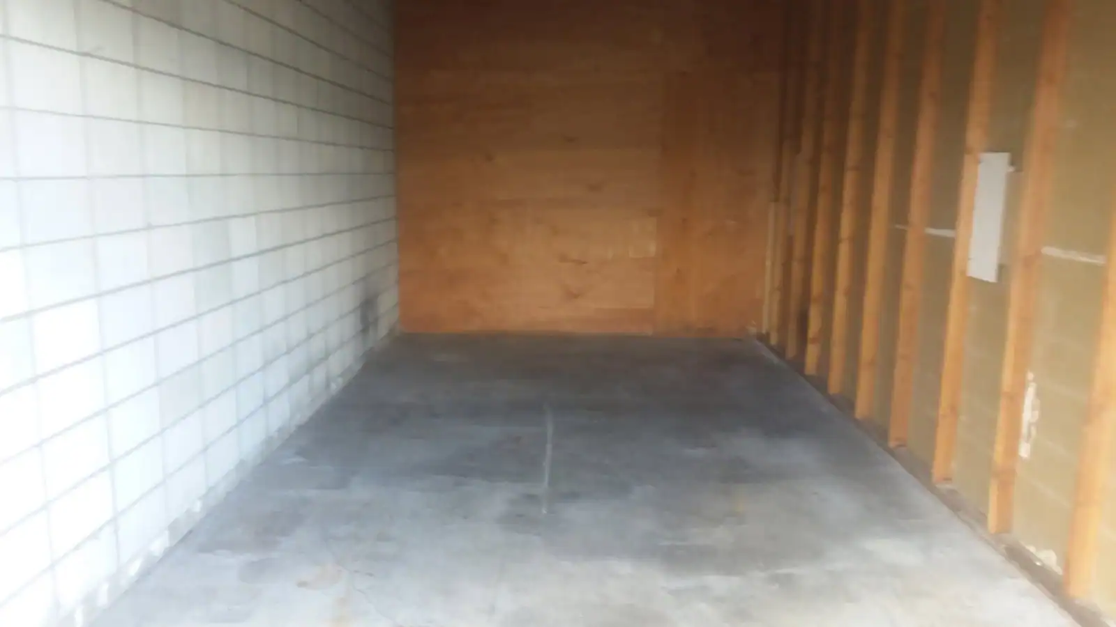 The same storage unit cleared out to the bare floor