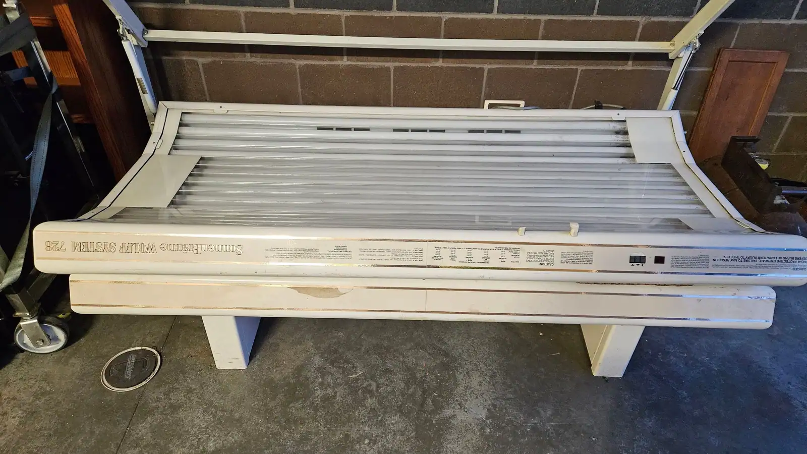 An old tanning bed pulled out of a salon