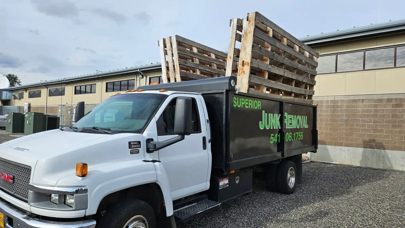 The Superior Junk Removal truck loaded high with wood pallets